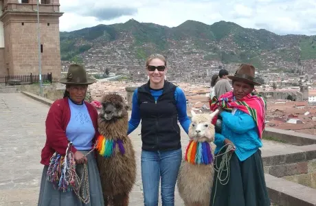 一名妇女与美洲驼和两名秘鲁妇女合影