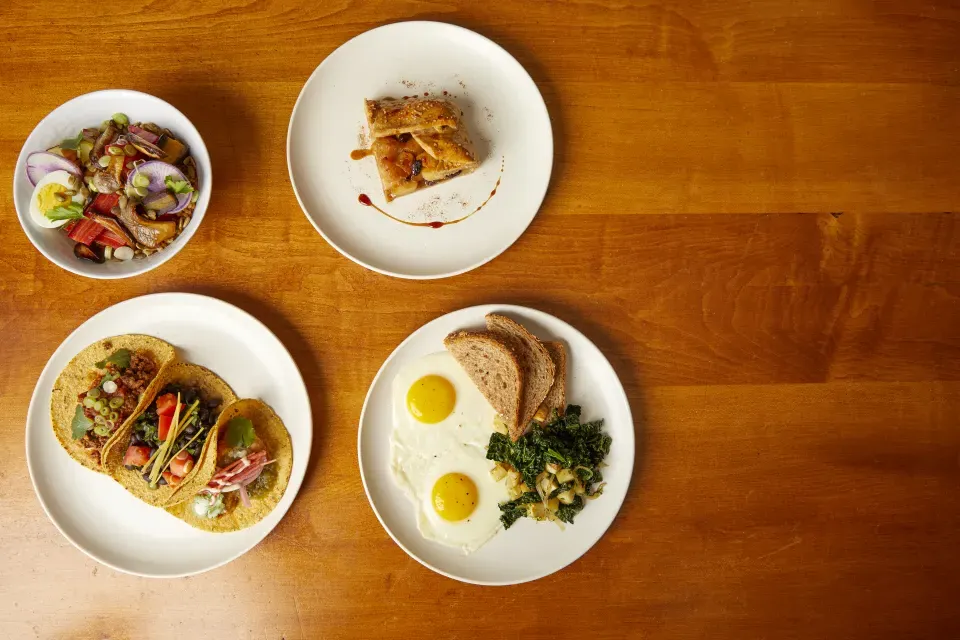 Aerial view of four plates of food prepared at Smith.